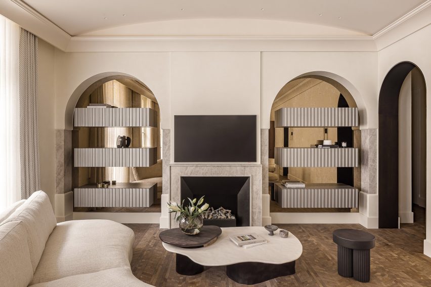 Living room with parquet floors, bronze mirrors and marble accents