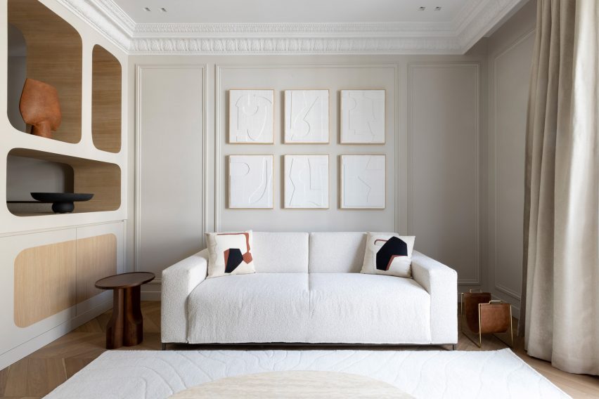 Living room with a white sofa in a 19th-century Parisian apartment building