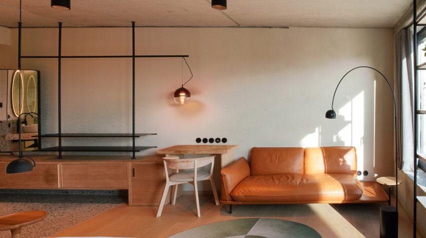 Seating area in guest room of hotel by Studio Aisslinger 