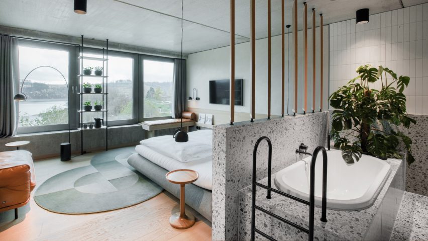 Renovated bedroom interior in hotel by Studio Aisslinger 