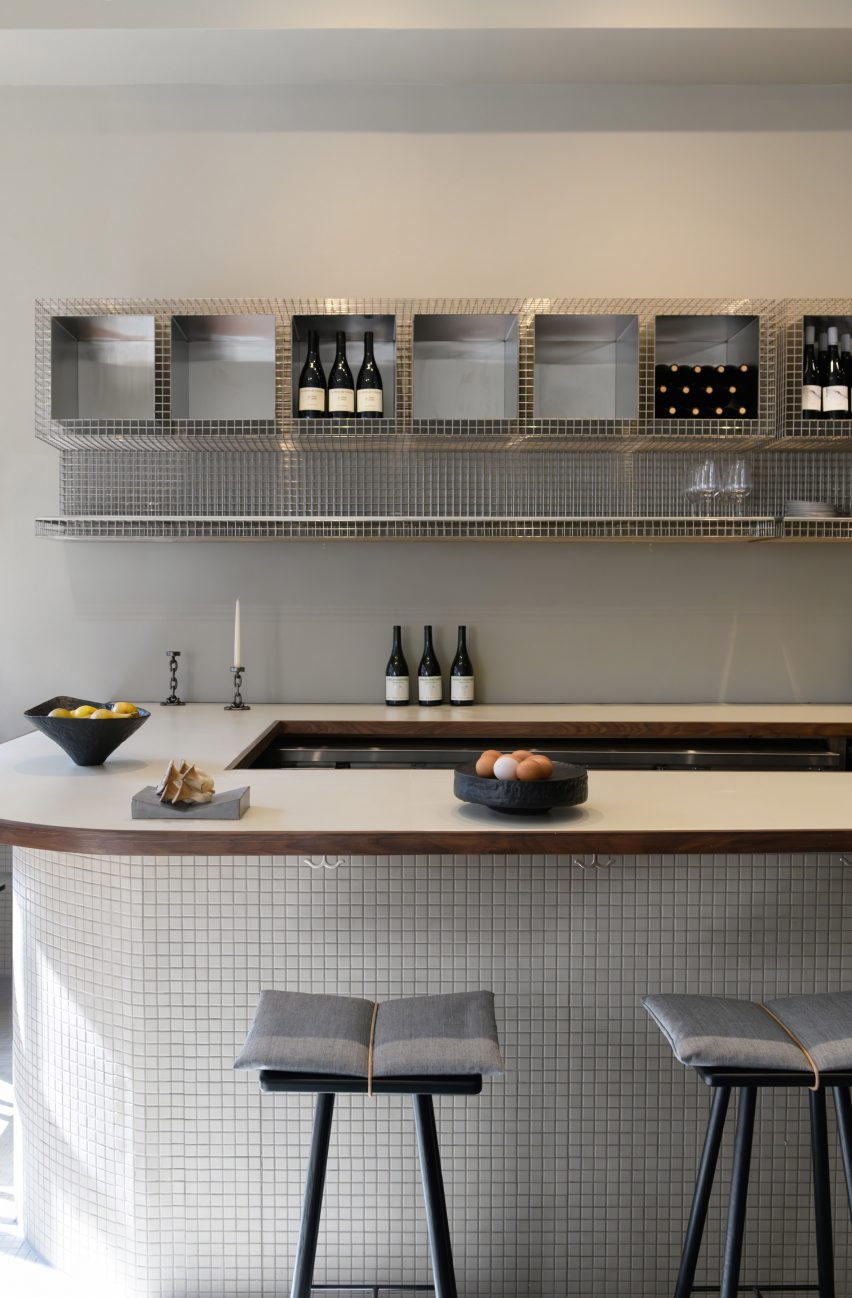 Bar counter with metal-mesh shelving behind