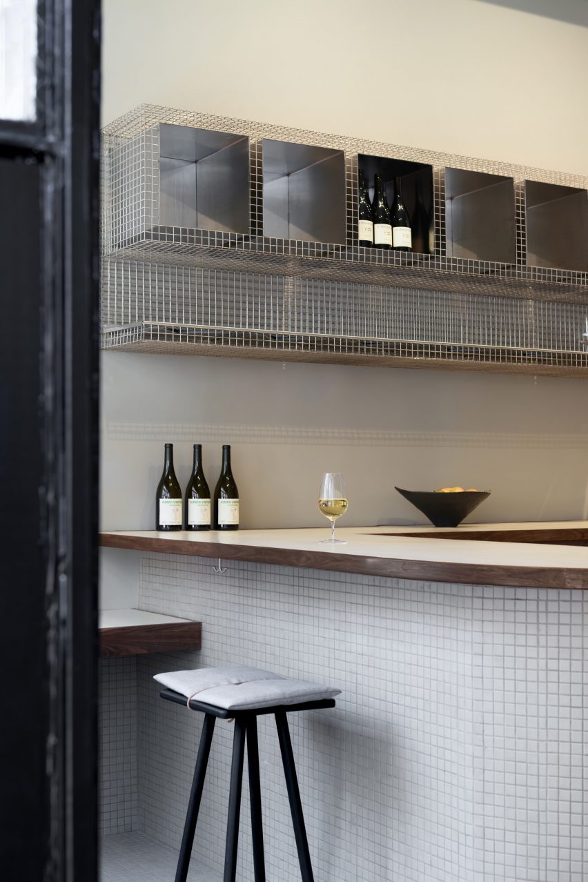 Small square tiles covering the front of a bar counter