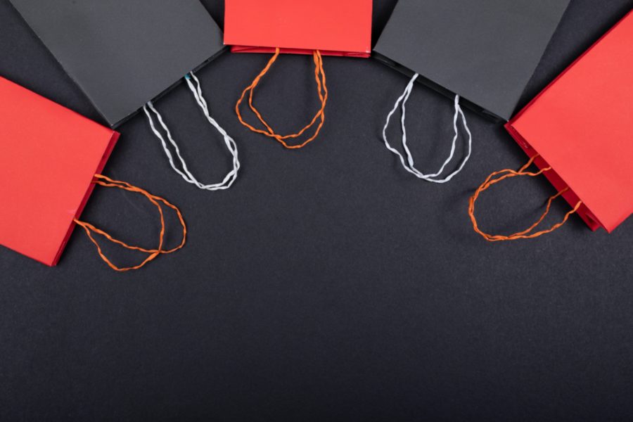 A picture with red and white gift bags on a black bakground