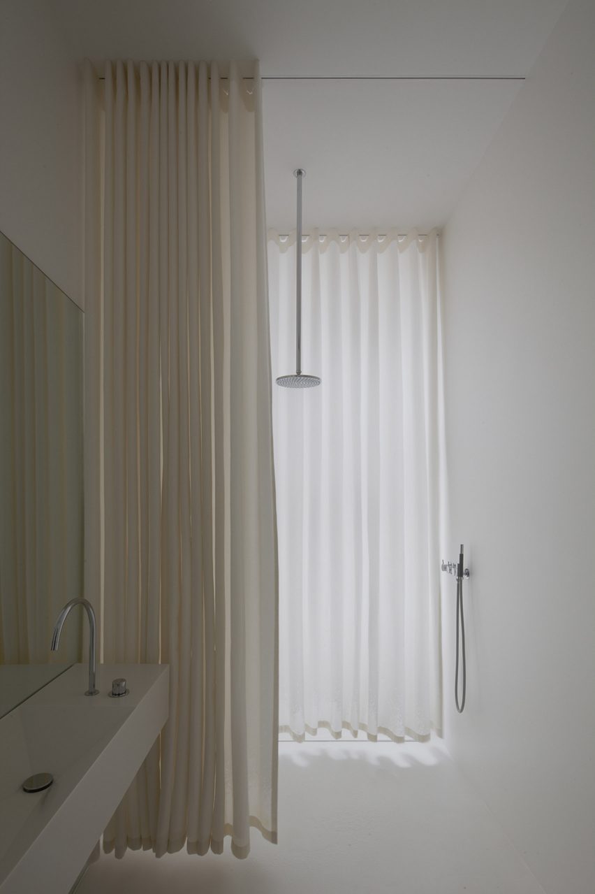 White bathroom with shower curtains