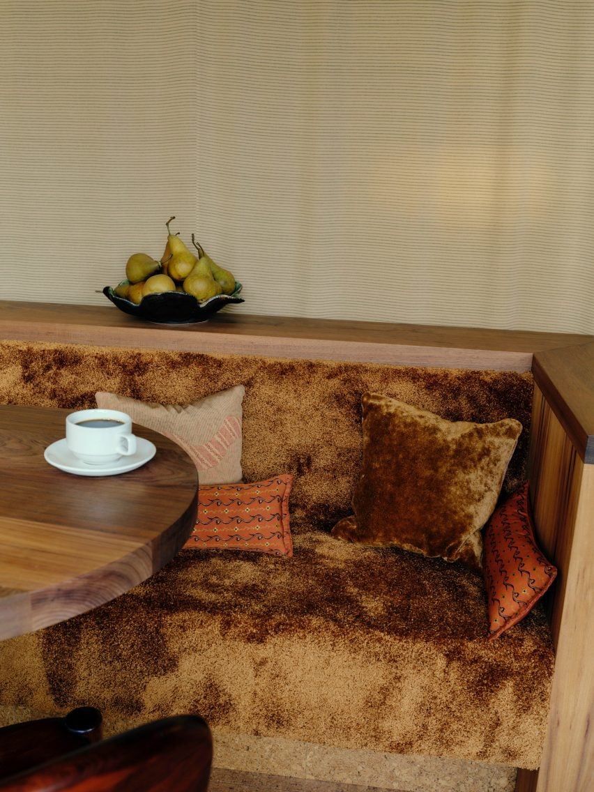 Banquette seating with timber joinery and fluffy carpet lining