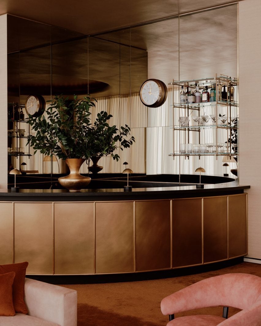 Bar at the refreshed Keebler J Straz Lounge featuring a matte brass front and black stone top