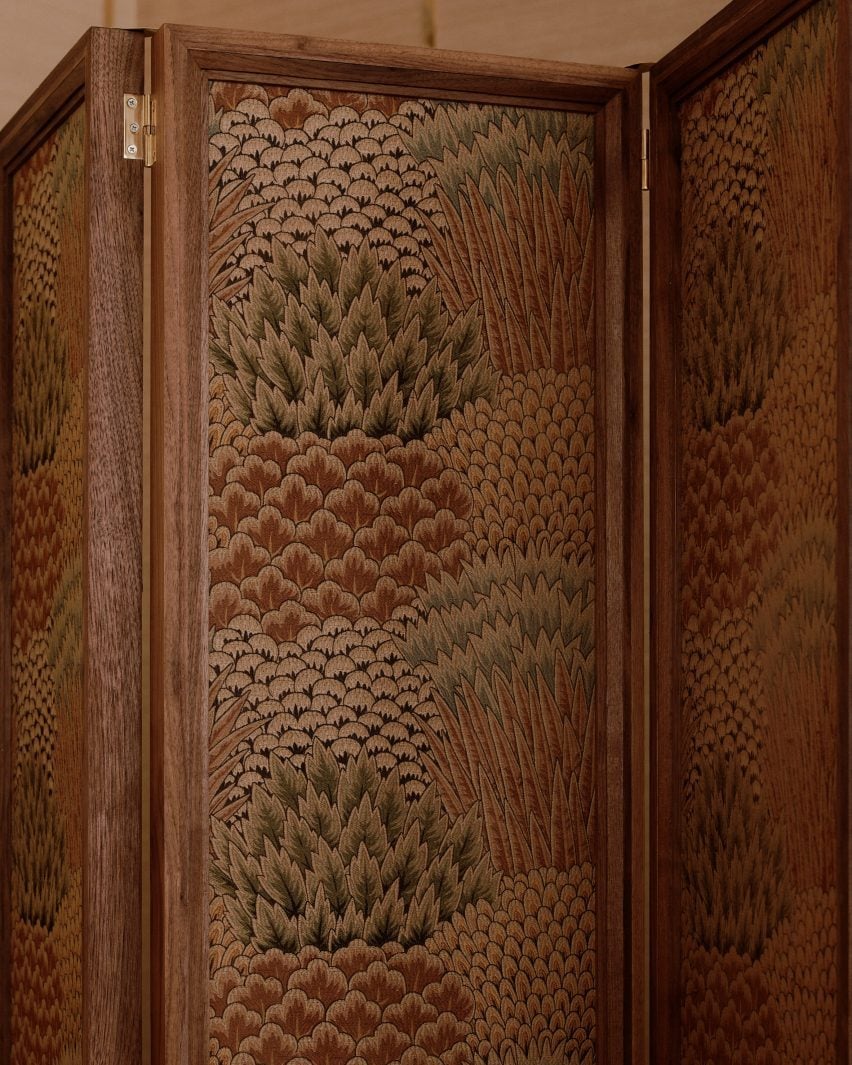 Close-up of a patterned screen with walnut frame