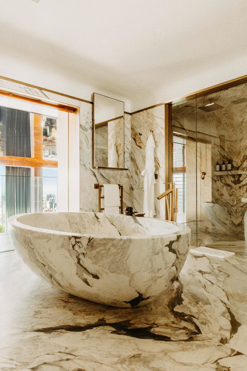 Marble-lined bathroom with an egg-shaped tub