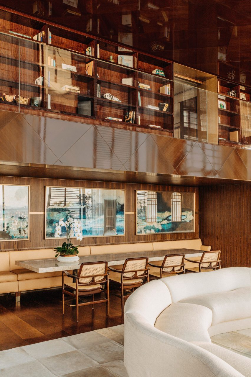 Dining area below a mezzanine with a bookcase