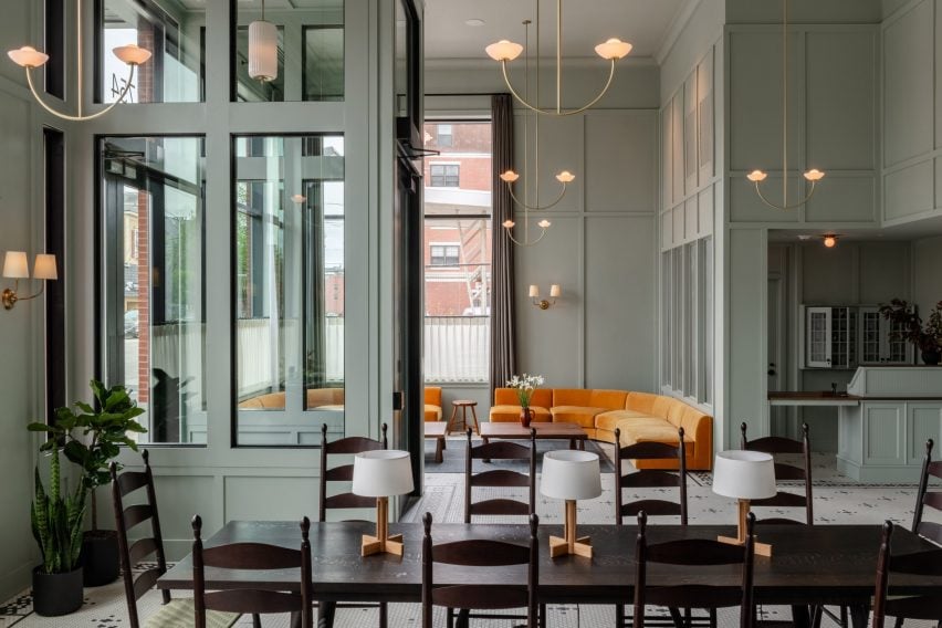 Lobby of The Longfellow Hotel featuring turmeric-coloured sofas and pale seafoam-green walls