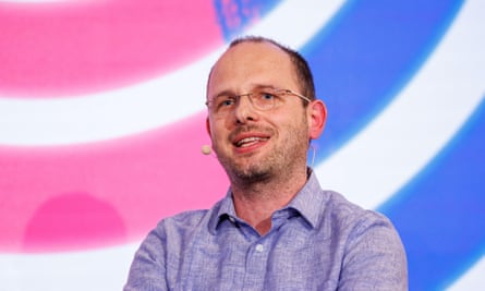 Thomas Dohmke wearing a headset microphone speaking at an event