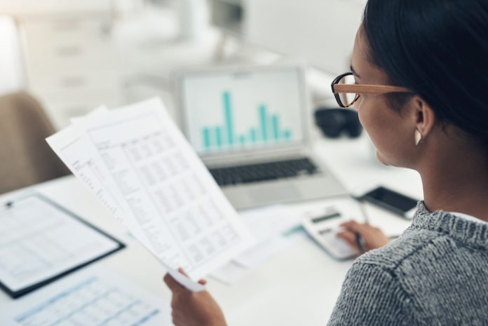Closeup shot of an unrecognisable businesswoman calculating finances in an office revenue management