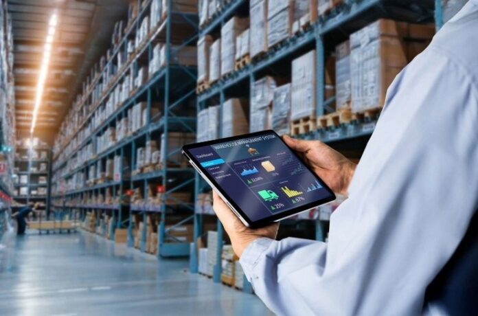 Person in warehouse with tablet FD-GoodHousekeeping
