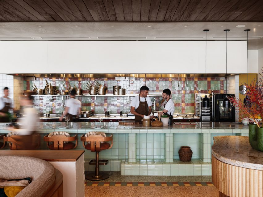 Bar top seating with colourful tiled backdrop
