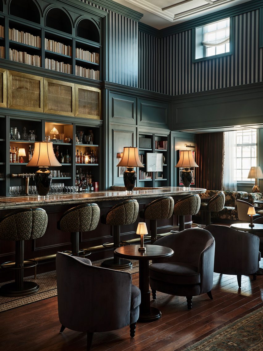Blue-green tones and striped wallpaper in a bar area