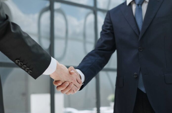 handshake of business partners in the background of the office.
