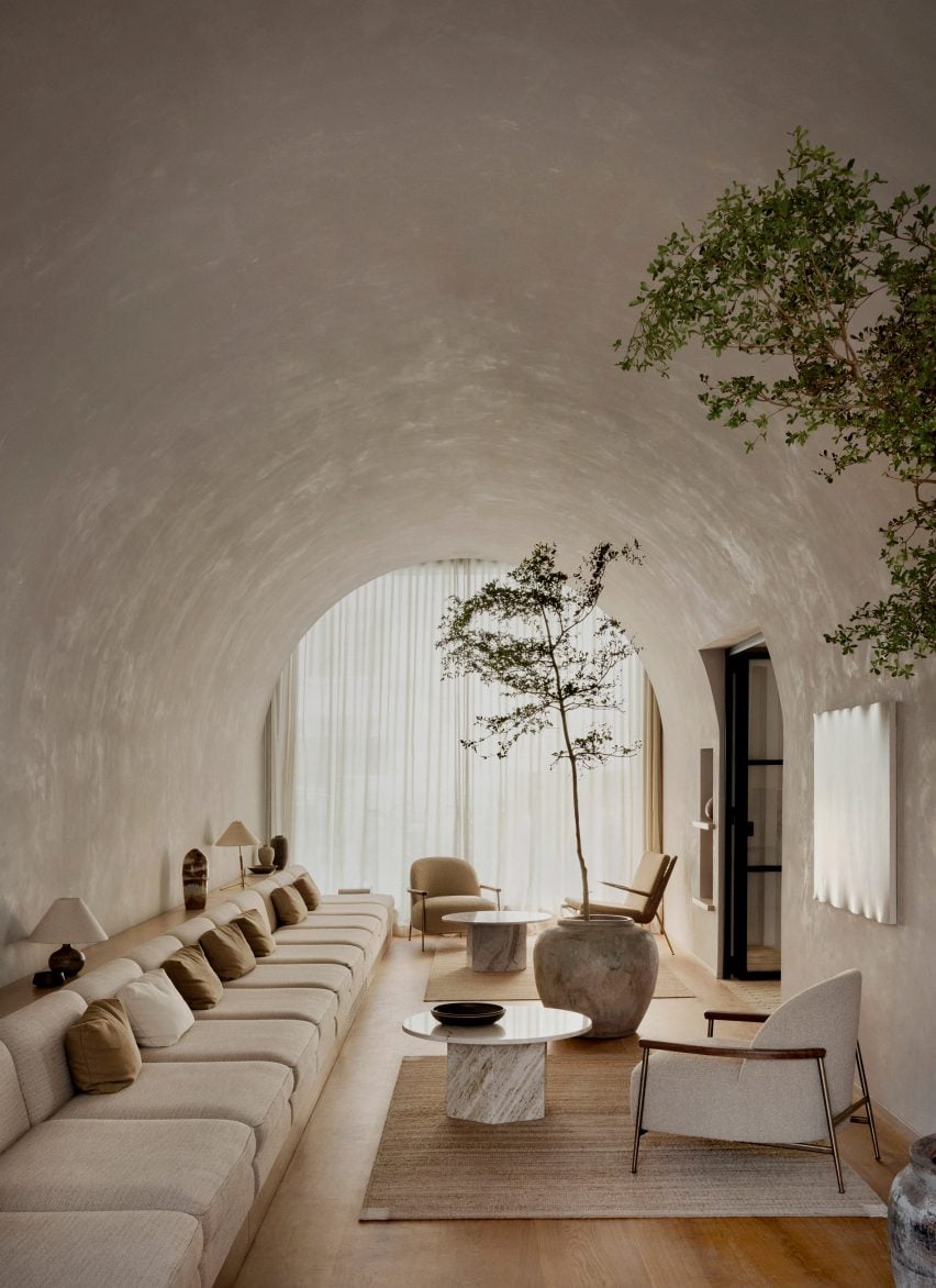 Indoor seating area with curved roof and plants