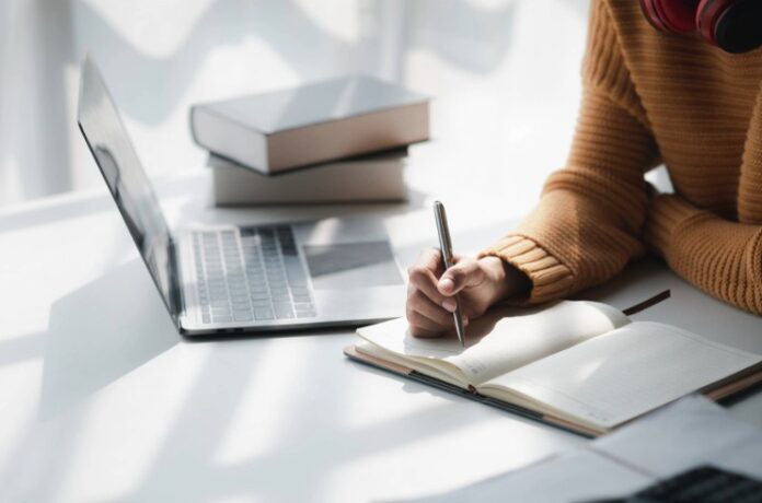 AdobeStock_572860227-learning-stock learning stock, woman with notepad and laptop