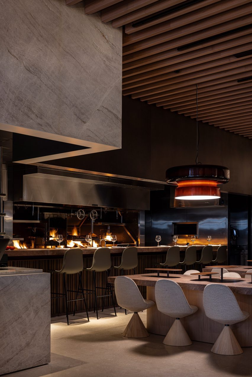 Two granite tables positioned close to an open-fire kitchen