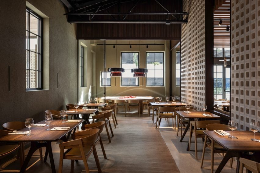 Dining area in an industrial-style building with blockwork partitions on the right side