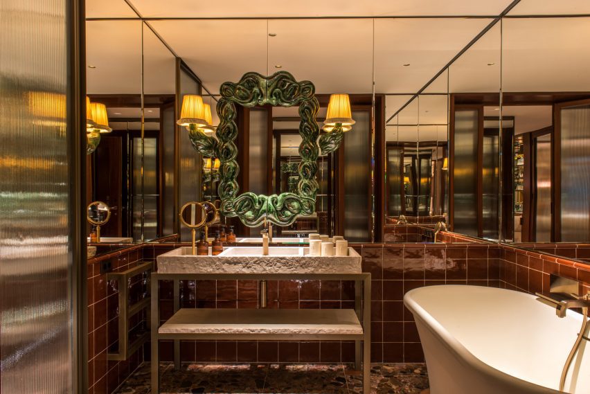 Glazed terracotta frame on mirrored bathroom wall