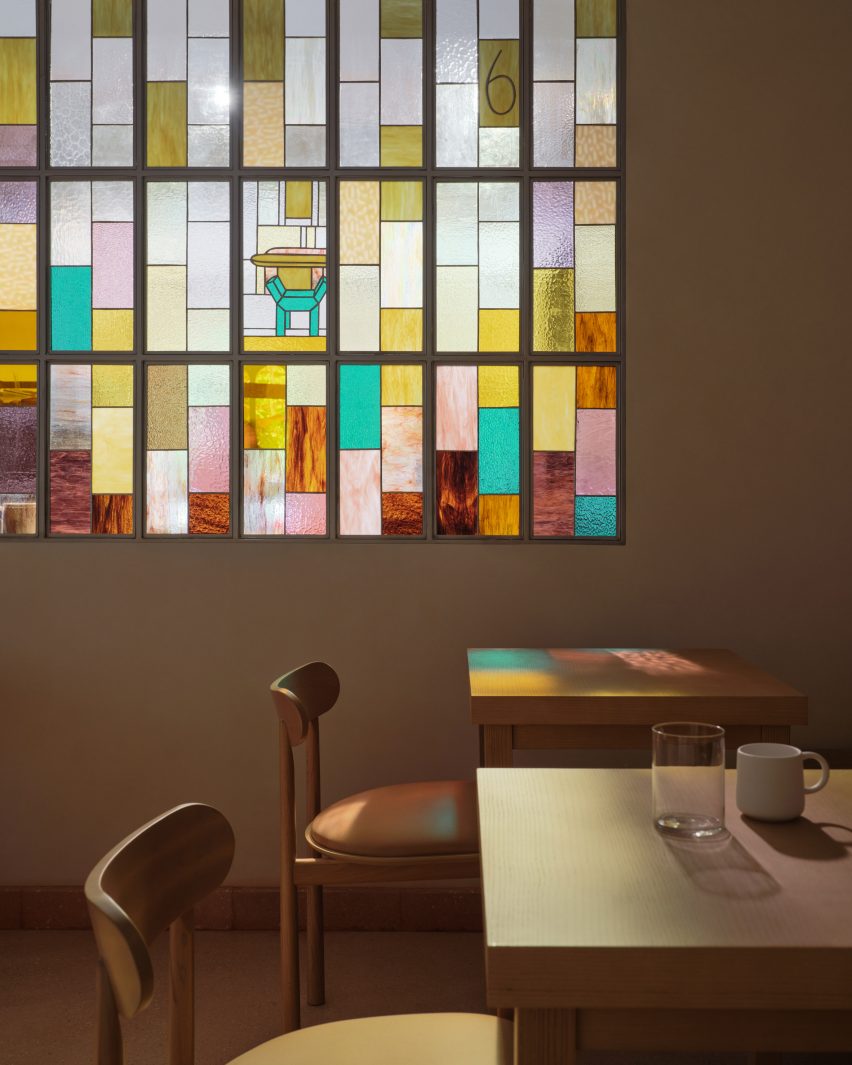 Colourful stained glass window filters light into cafe