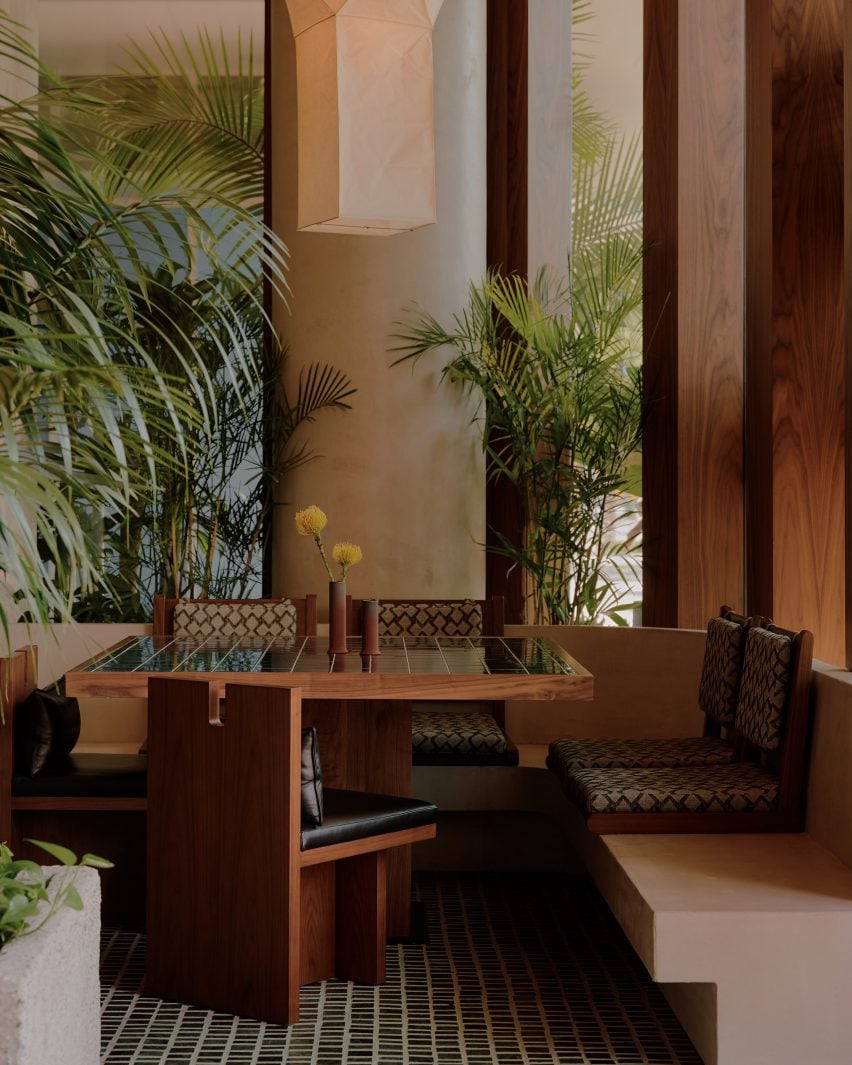 Seating booth with green tiles on the floor and table top