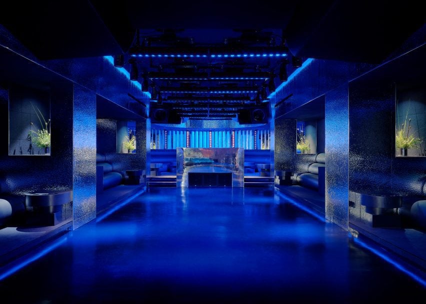 Open dance floor surrounded by seating niches and hammered metal walls