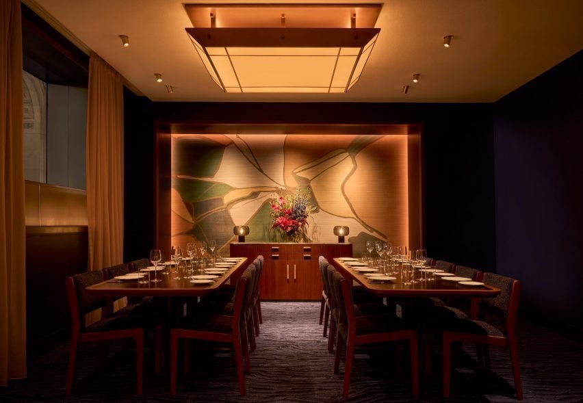 A private dining room featuring abstract murals at each end