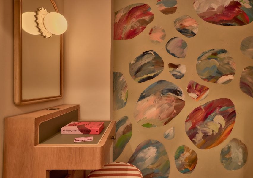 A small table beside a colourful wall mural