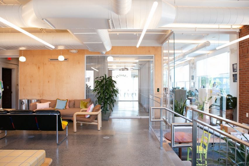 Cafe area with eclectic furniture, plywood walls and glass partitions