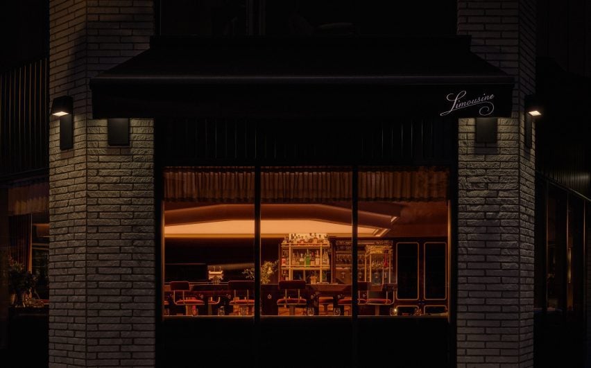 Exterior of a restaurant with a view into a softly glowing dining room