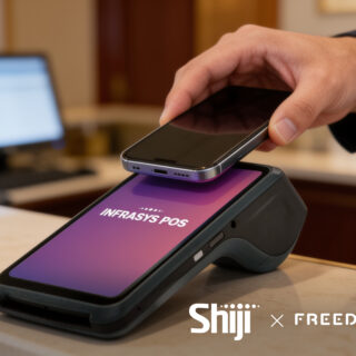 Hand places a smartphone on a payment terminal at checkout; screen reads INFRASYS POS.