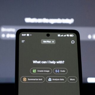 Close-up of a smartphone screen showing a help menu with rounded option buttons (Create image, Code, Summarize text, Analyze data). The header reads 'What can I help with?'