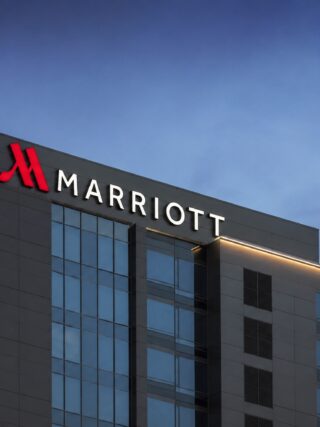 marriott logo on top of a hotel building (AI generated)