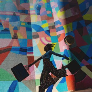 Person wearing patterned pants and boots walks along a vivid geometric mural, with a round mirror on the wall to the right.