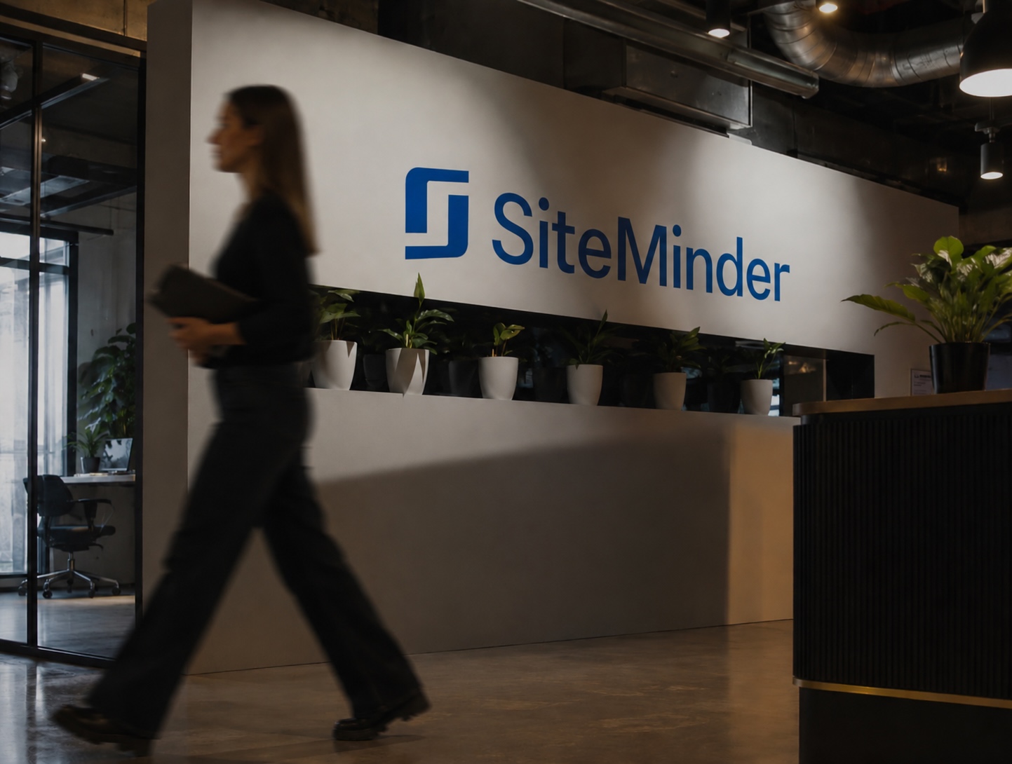 image of siteminder logo on a wall, person walking by. ai generated