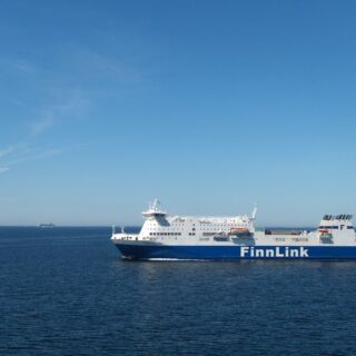 Large FinnLink passenger ferry sailing on calm blue sea under a clear sky