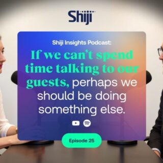 Two people sit across from each other in a podcast studio, with a colorful promo card in between that reads: “Shiji Insights Podcast: If we can’t spend time talking to our guests, perhaps we should be doing something else.” Episode 25 badge visible below.