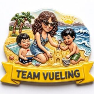 Cartoon of a woman and two children building a sandcastle on a sunny beach; palm trees and waves in the background, banner reads TEAM VUELING.