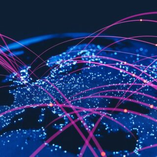 Global network map with illuminated blue continents and pink connecting lines symbolizing internet connections.