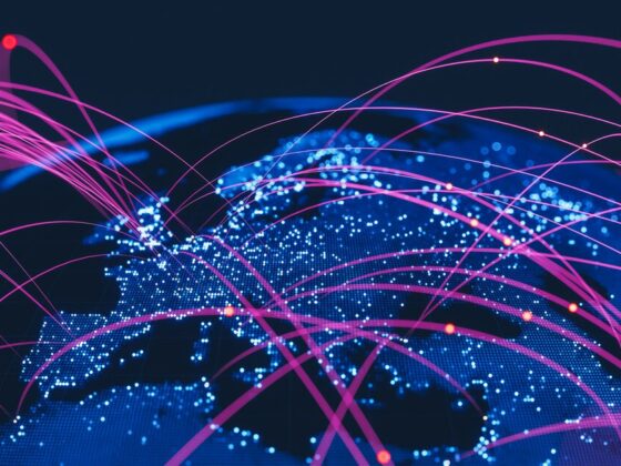 Global network map with illuminated blue continents and pink connecting lines symbolizing internet connections.