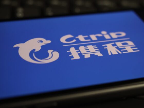 Blue screen showing the Ctrip logo with a white dolphin icon and Chinese text on a blue background, as seen on a device screen