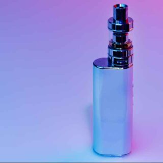 Silvery vape mod standing upright on a blue-pink gradient background.