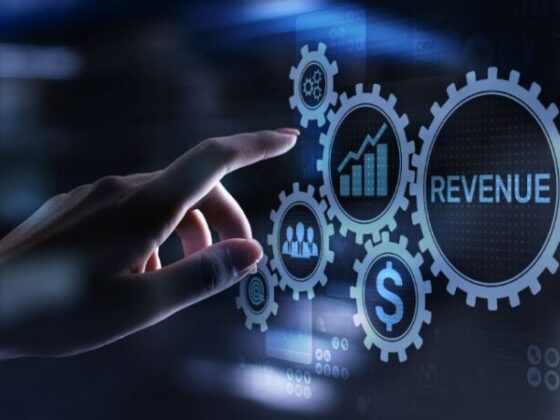Hand interacts with glowing gears representing revenue and growth in a digital analytics interface.