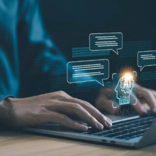 Person typing on a laptop with a glowing AI brain hologram and chat bubbles representing AI-powered conversations.