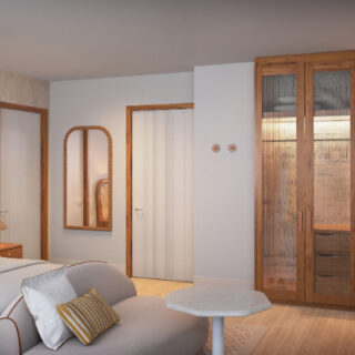 Hotel room with a king bed, beige sofa, wall mirror, wooden wardrobe, marble coffee table, and an orange backlit tea station.