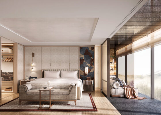 Luxurious hotel suite with a king bed, seating area, open wardrobe on the left, and large glass walls with a scenic view.