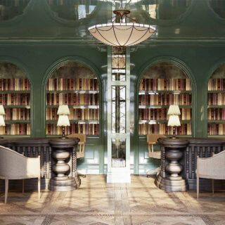 Luxurious library alcove with green arches, tall bookcases, central mirrored pillar, and plush seating.