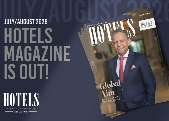 Announcement banner for Hotels Magazine July/August 2026 with a stacked magazine cover showing a man in a navy suit and red tie on the front.